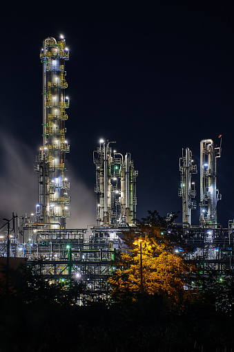 night time silhouette of oil refinery Schwedt producing fuel from russian oil pipe druschba