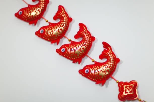 Auspicious fish pendant decoration: a symbol of wealth and feng shui Auspicious fish pendant decoration: a symbol of wealth and feng shui gold arowana stock pictures, royalty-free photos & images