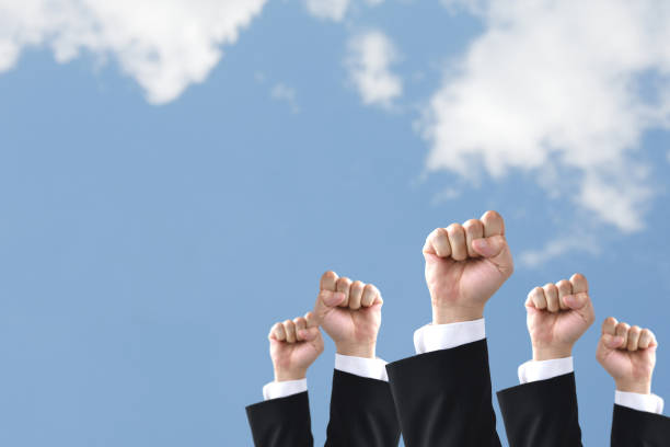 istock Businessmen's hands rising to blue sky 1406287195