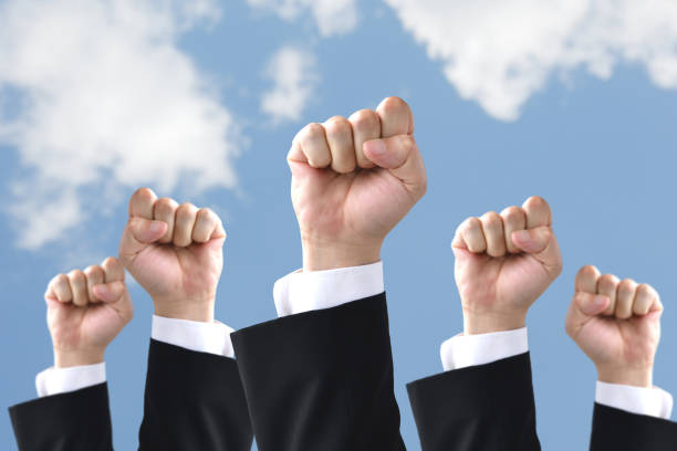 istock Businessmen's hands rising to blue sky 1406287290