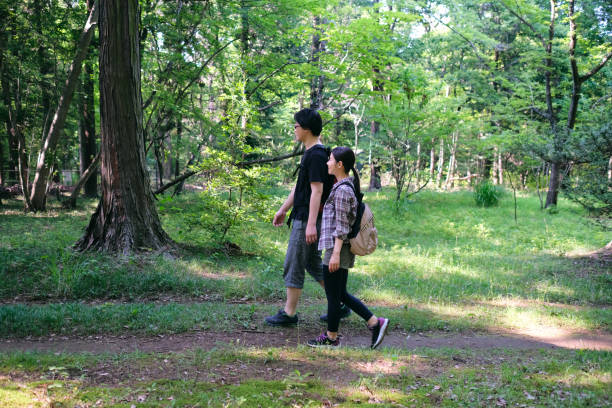 istock Side view of couple hiking in forest 1406287376