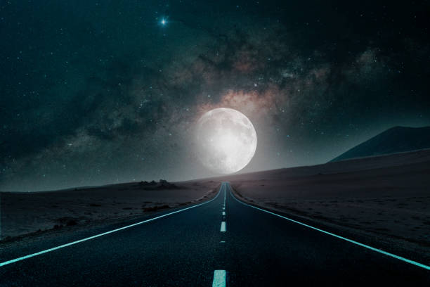 road to the moon in the desert background stock photo