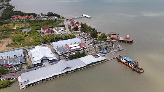 General Aerial View of The Seaside Town of Kuala Perlis. Photos showing aerial view of the Kuala PErlis waterfront, ferry terminal, jetty and commercial buildings by the coast