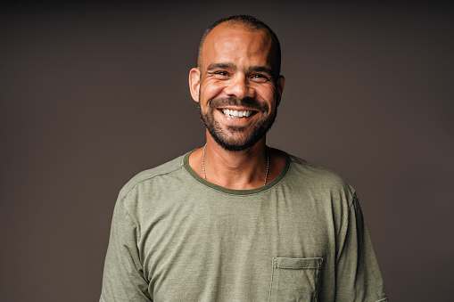 Happy and relaxed middle aged man in studio