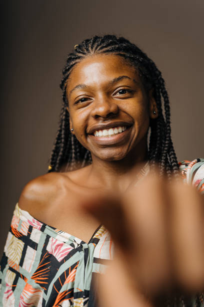 istock Smiling woman pointing at camera 1406290057
