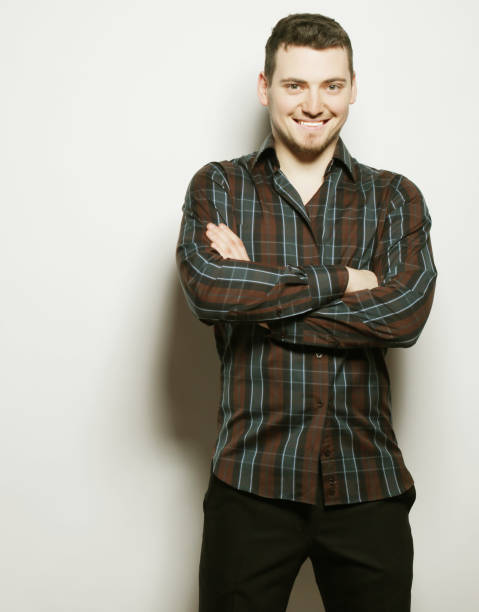 istock Handsome young man in shirt looking at camera 1406293219
