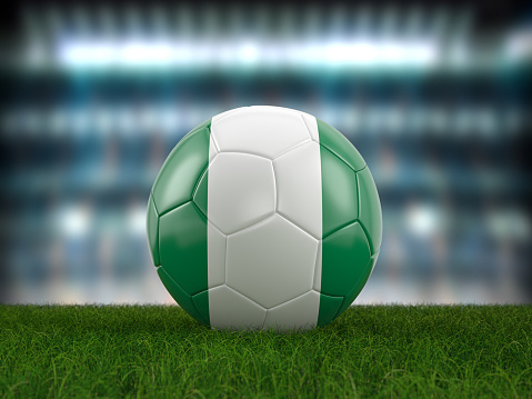 Soccer ball Nigeria flag on a soccer pitch. 3d illustration.