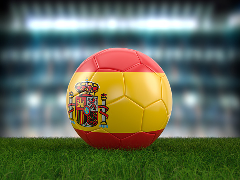 Soccer ball Spain flag on a soccer pitch. 3d illustration.