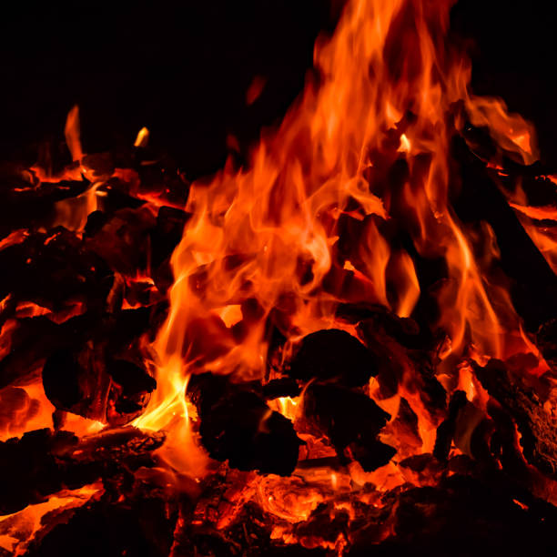 istock Fire flames on black background, Blaze fire flame texture background, Beautifully, the fire is burning, Fire flames with wood and cow dung bonfire 1406297798