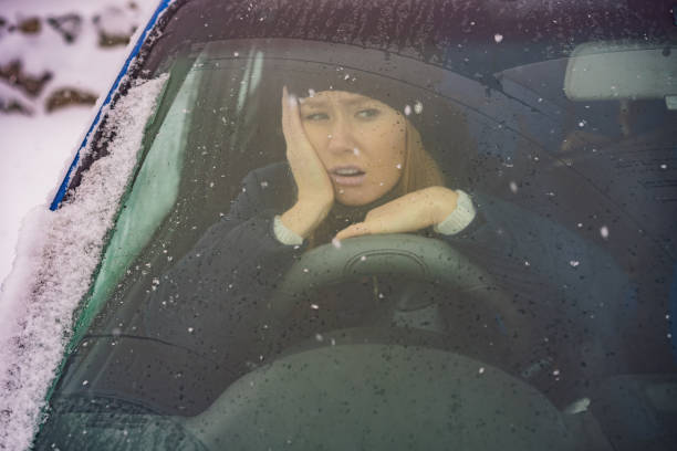 istock Woman in a car during a snowfall, problems on the road 1406297883