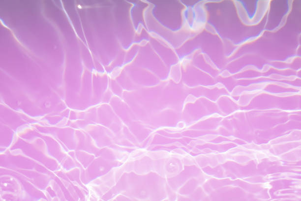 istock Defocus blurred transparent orange colored clear calm water surface texture with splashes and bubbles. Trendy abstract nature background. Water waves in sunlight. Calm orange water background. 1406298782