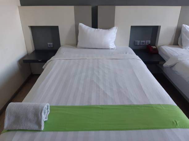 istock hotel rooms 2 beds with white sheets 1406298810
