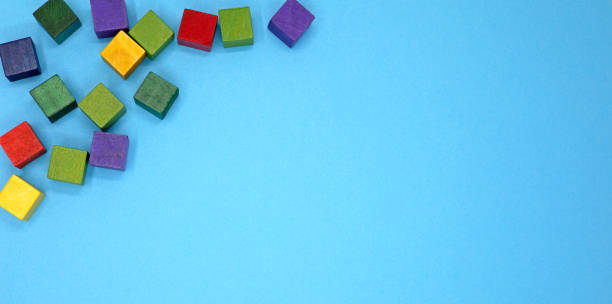 istock blue background with colorful small wooden cubes 1406303211
