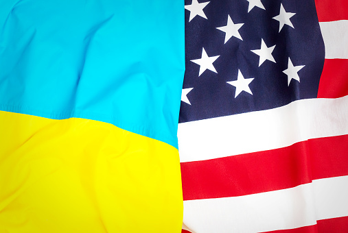 Ukrainian and US flags as background.\nUkraine and USA partnership.