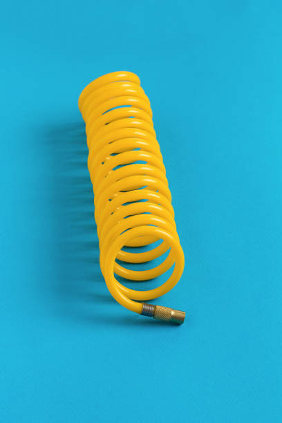 istock Yellow hose for connecting to a car compressor on a blue background. 1406304891