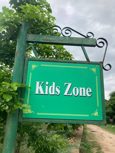 istock green kids zone signboard on the roadside with trees 1406306414