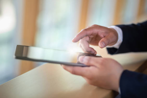 Businessman working on digital tablet close up view of hands