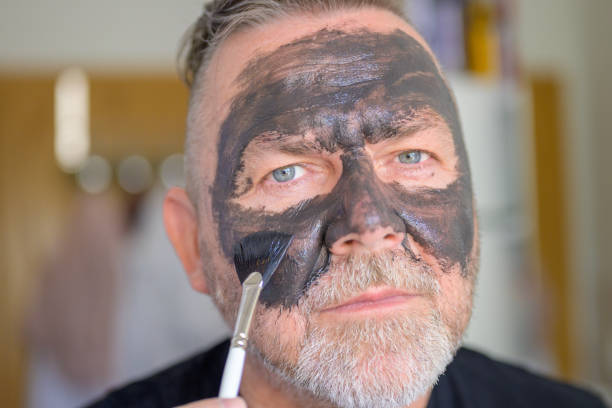 istock Man in his fifties applying a face mask 1406314418