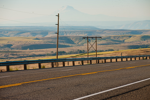 An empty open road with no traffic on it, in a rural scenic area in the Pacific Northwest.