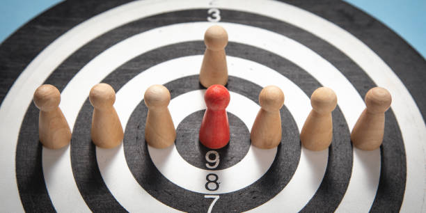 istock Wooden human figures on target dartboard. Target. Success. Business 1406318451