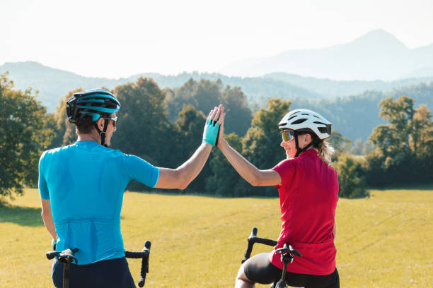 istock Racing cyclists looking at sunset over mountain tops, aerial shot 1406319639
