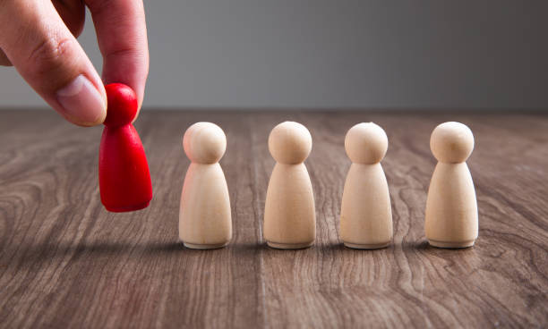 istock Businessman hand choose people standing out from the crowd. 1406319643
