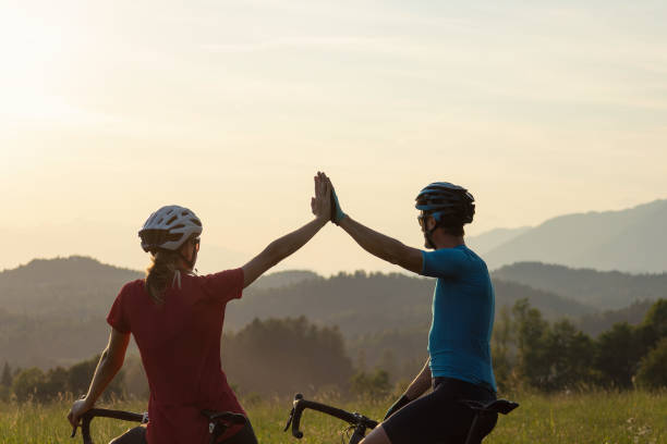 istock Two road cyclists on a glade with mountain view at sunset, aerial shot 1406319689