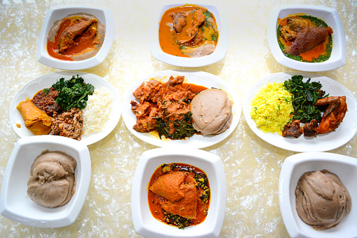 An image of various popular Nigerian delicacies including amala, egusi, ewedu, vegetable soup.