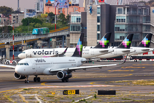 Mexico City, Mexico - April 14, 2022: Volaris Airbus A320 airplanes at Mexico City airport (MEX) in Mexico.