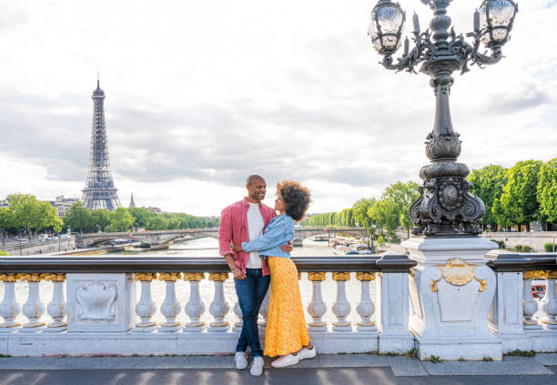 Afro-american beautiful couple in love visiting Paris stock photo