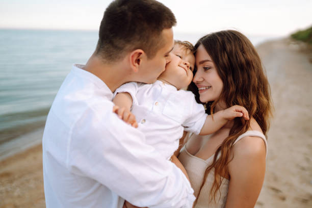istock Cute  family are having fun on the beach. 1406325295