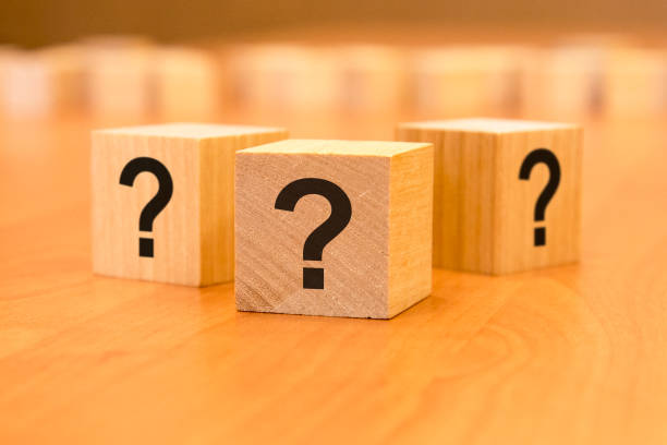 istock cube with question mark on wooden background. space for text 1406329958