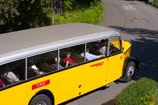 Classic yellow Swiss Post bus brand Saurer at City of Zürich on a sunny summer Sunday. Photo taken July 2nd, 2022, Zurich, Switzerland.