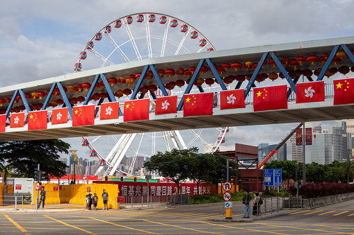 Hong Kong - June 29, 2022 : Footbridge decorated with China and Hong Kong flags to celebrate the 25th anniversary of the city's handover from Britain to China, in Central, Hong Kong.