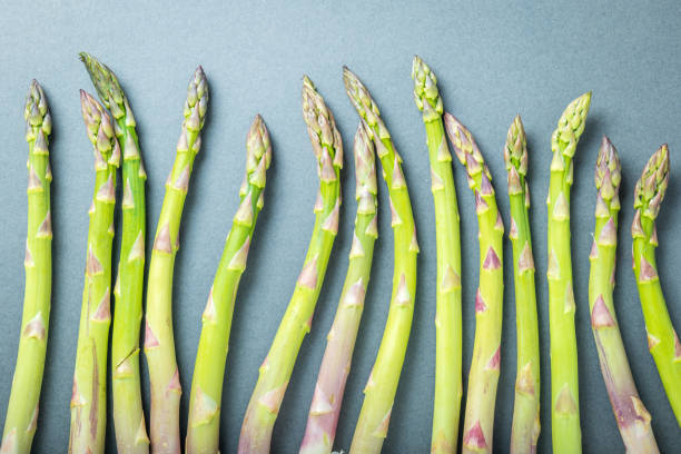 istock Fresh asparagus shoot over dark background 1406333248