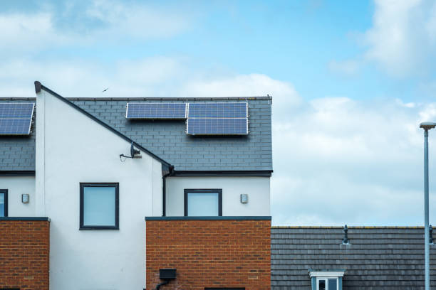 solar panels mounted on the roof of a modern new-build house in england uk - solar panel fotos imagens e fotografias de stock