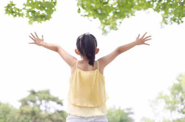 istock Little girl faced the future with open arms 1406333348