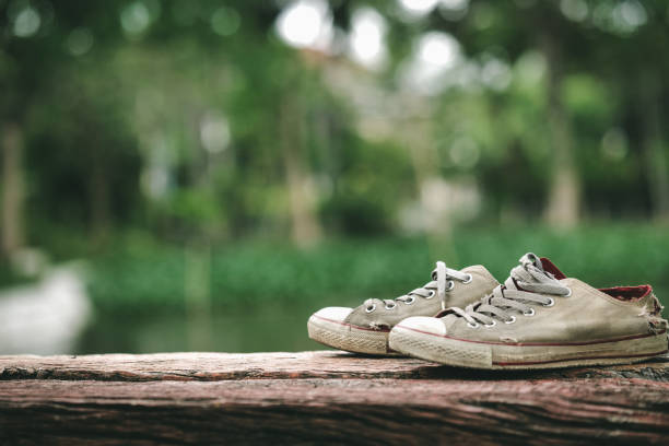 The Old Canvas shoes placed on the logs.Add noise and vignette to your photos for a vintage look.
