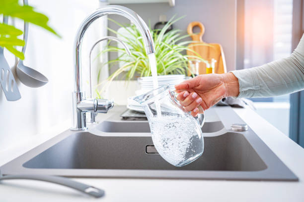 Filling jug with water from the tap