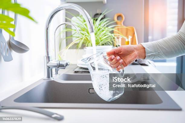 Filling Jug With Water From The Tap Stock Photo - Download Image Now - Water, Faucet, Drinking Water