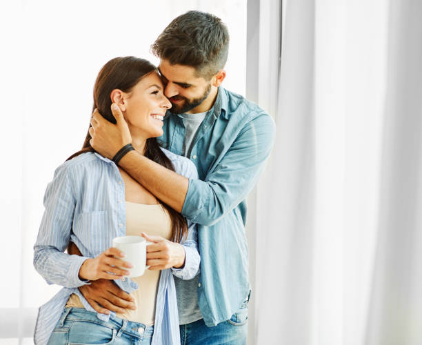 woman couple man happy happiness  love young lifestyle together romantic boyfriend girlfriend Portrait of a lovely young couple together at home boyfriend stock pictures, royalty-free photos & images