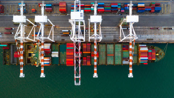 istock Container ship loading and unloading in deep sea port, Aerial top view of business logistic import and  export freight  transportation by container ship in open sea. 1406341823