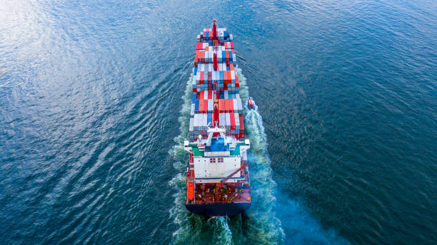 istock Container ship carrying container for business freight shipping import and export, Aerial view container ship arriving in commercial port. 1406341828