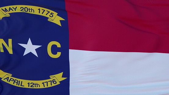 Flag of North Carolina state, region of the United States, waving at wind. 3d rendering.