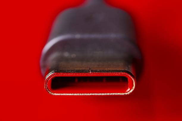 Close-up of USB Type-C cable on red background.