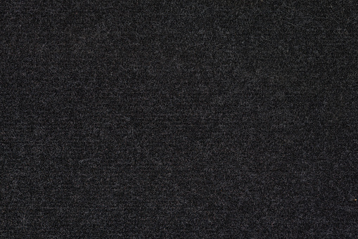 texture and full-frame macro background of black synthetic car carpet.