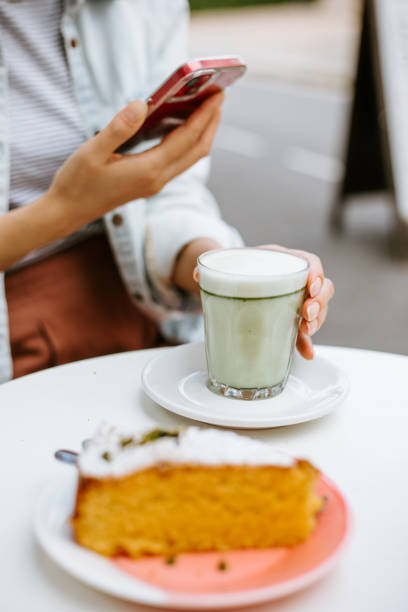 istock Woman hand holding macha latte 1406343915