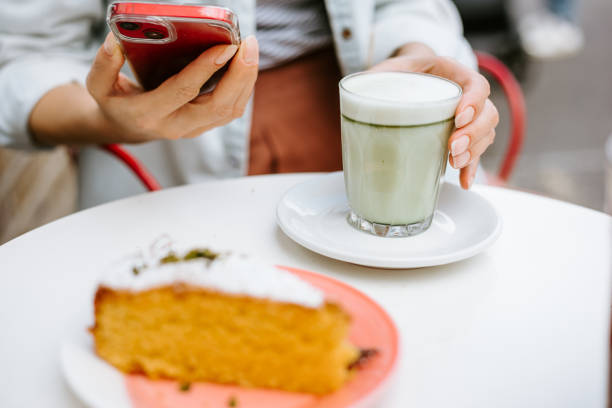 istock Woman hand holding macha latte 1406343942