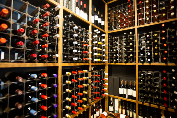 wine bottles on a large wine rack - wine bottle liquor store wine variation imagens e fotografias de stock