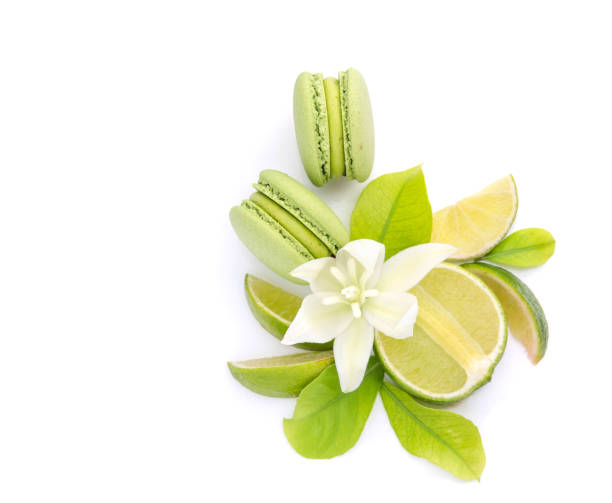 istock Juicy lemon fruit and green macarons on a white background 1406345782